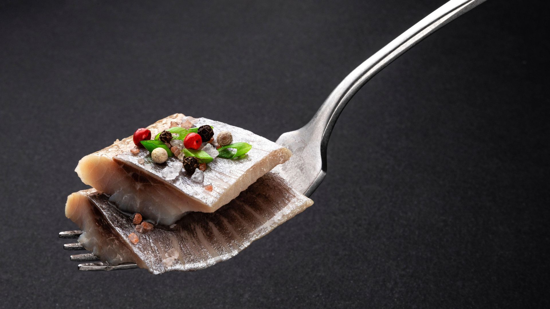 A fork full of salted herring