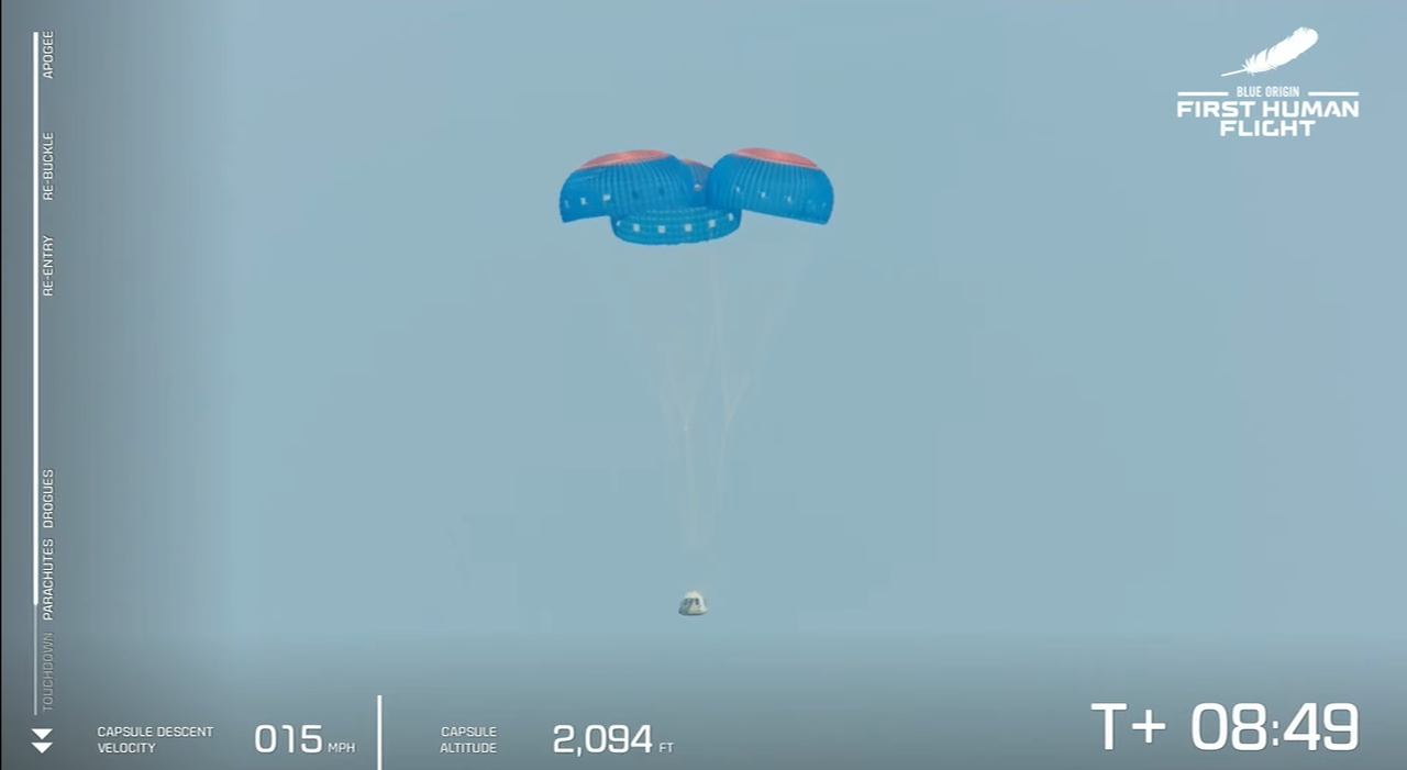 The New Shepard capsule and its main parachutes during flight on July 20, 2021.