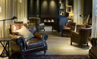Leather armchairs in front of fire