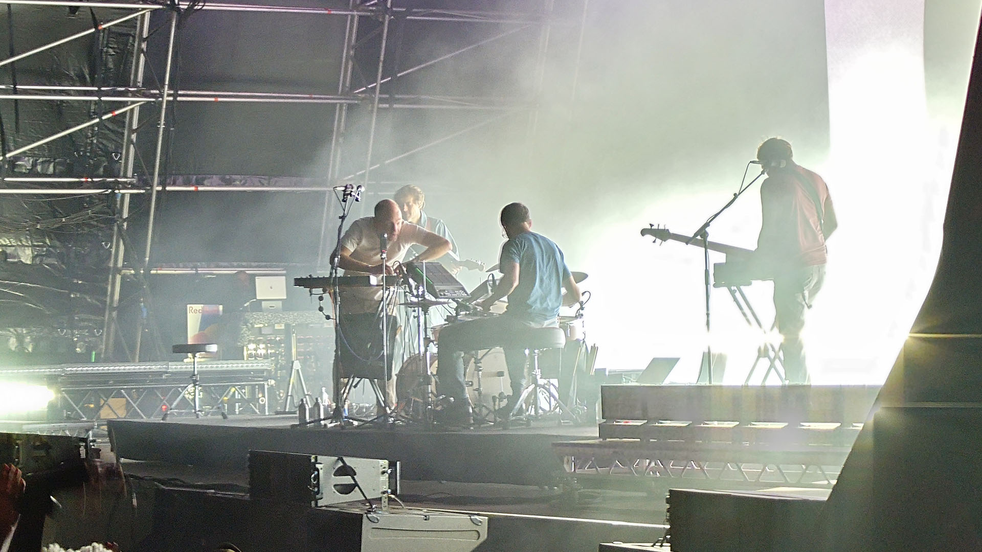 A photo of the act Caribou playing on stage.
