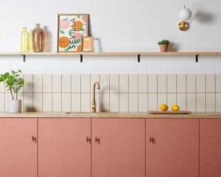 Apricot cabinets with kit-kat style backsplash tiles and coordinating coral grout.