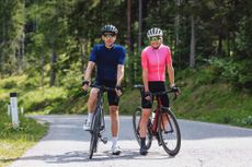 A man and a woman on their bikes next to each other on a path.