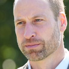 A headshot of Prince William wearing a white shirt and blazer looking thoughtful