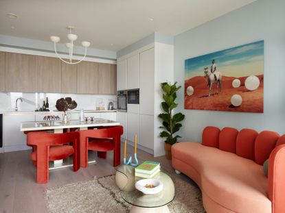 contemporary interior with red upholstered dining chairs and sofa 