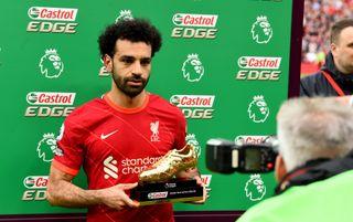 Liverpool forward Mo Salah holding the 2021-22 Premier League Golden Boot trophy