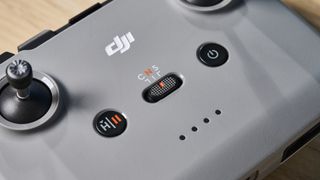 A gray DJI Neo drone with a camera