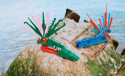 View of Serban Ionescu's multicoloured ICES (In Case of Emergency Sculptures) pictured outside in front of a body of water