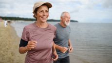 What is exercise: Image shows active senior couple jogging along beach
