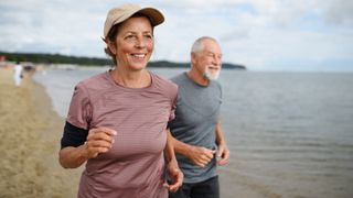 What is exercise: Image shows active senior couple jogging along beach