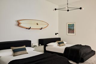 A surfboard displayed on a bedroom wall
