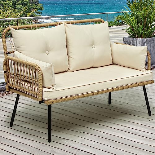 Yitahome Patio Furniture Wicker Outdoor Loveseat on wood paneled floor in front of large plant in vase and view of ocean.