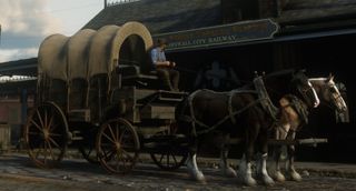 Arthur Morgan sitting in a horse-drawn wagon