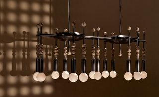Metal and marble light fixture with round lightbulbs