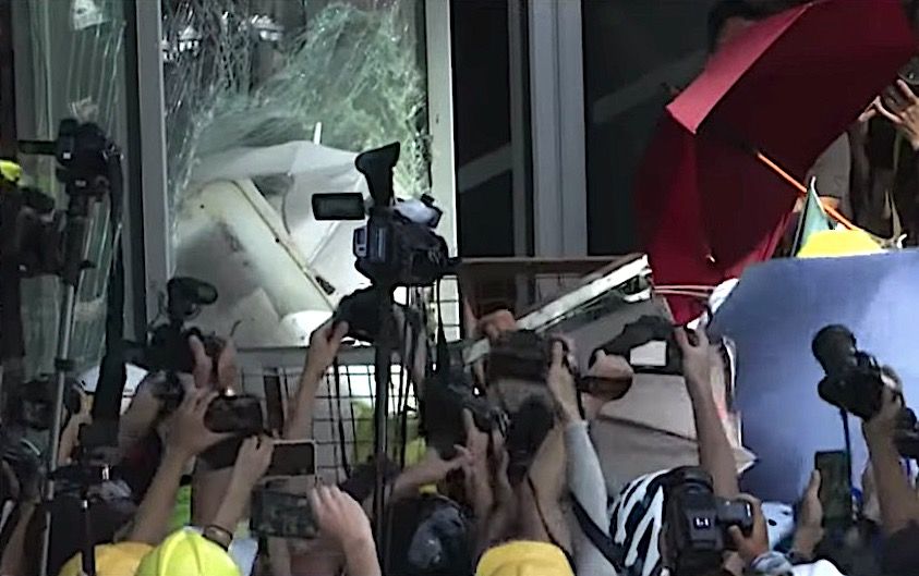 Hong Kong protesters smash window at legislature