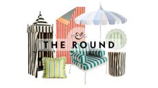 Striped outdoor decor – including a towel cabana, ruffle-border throw pillow, beach towel, scallop-edged iron chair, pagoda umbrella, irregular side table, and petal-shaped dinner plate –pictured against a white background