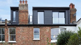 black slate clad dormer loft conversion on brick terraced house