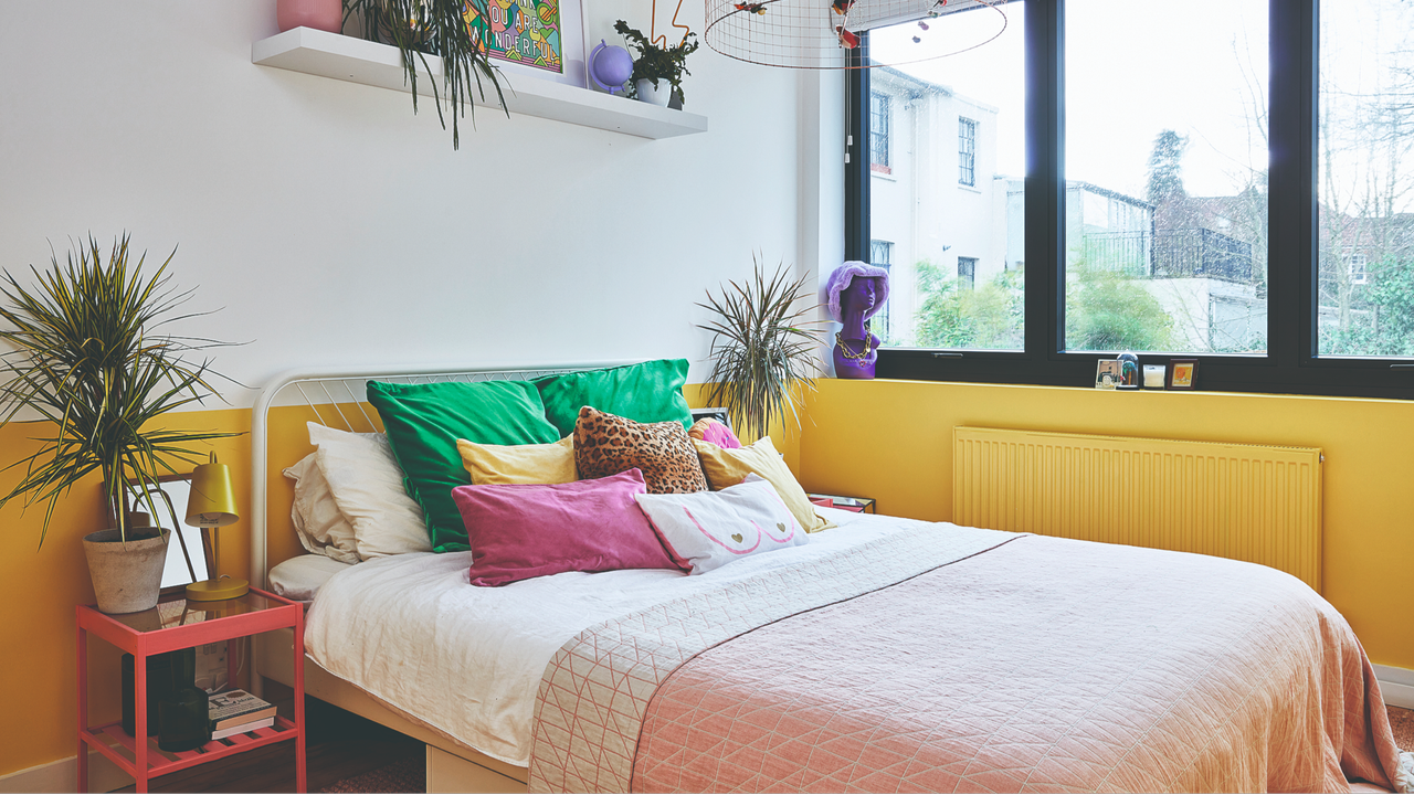Bedroom with yellow and white colour block wall, black steel windows