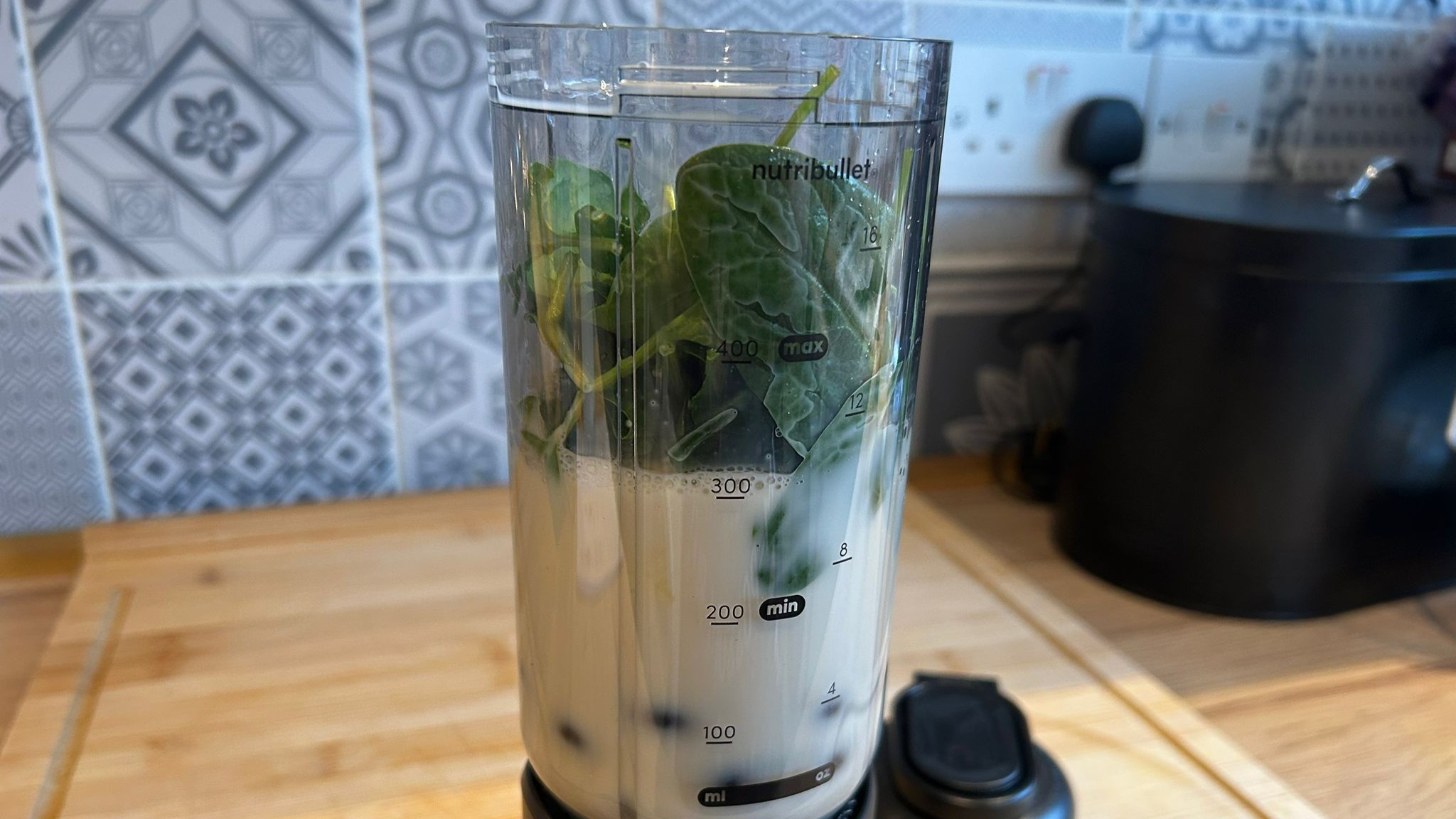 Nutribullet Flex blender containing banana kale smoothie ingredients