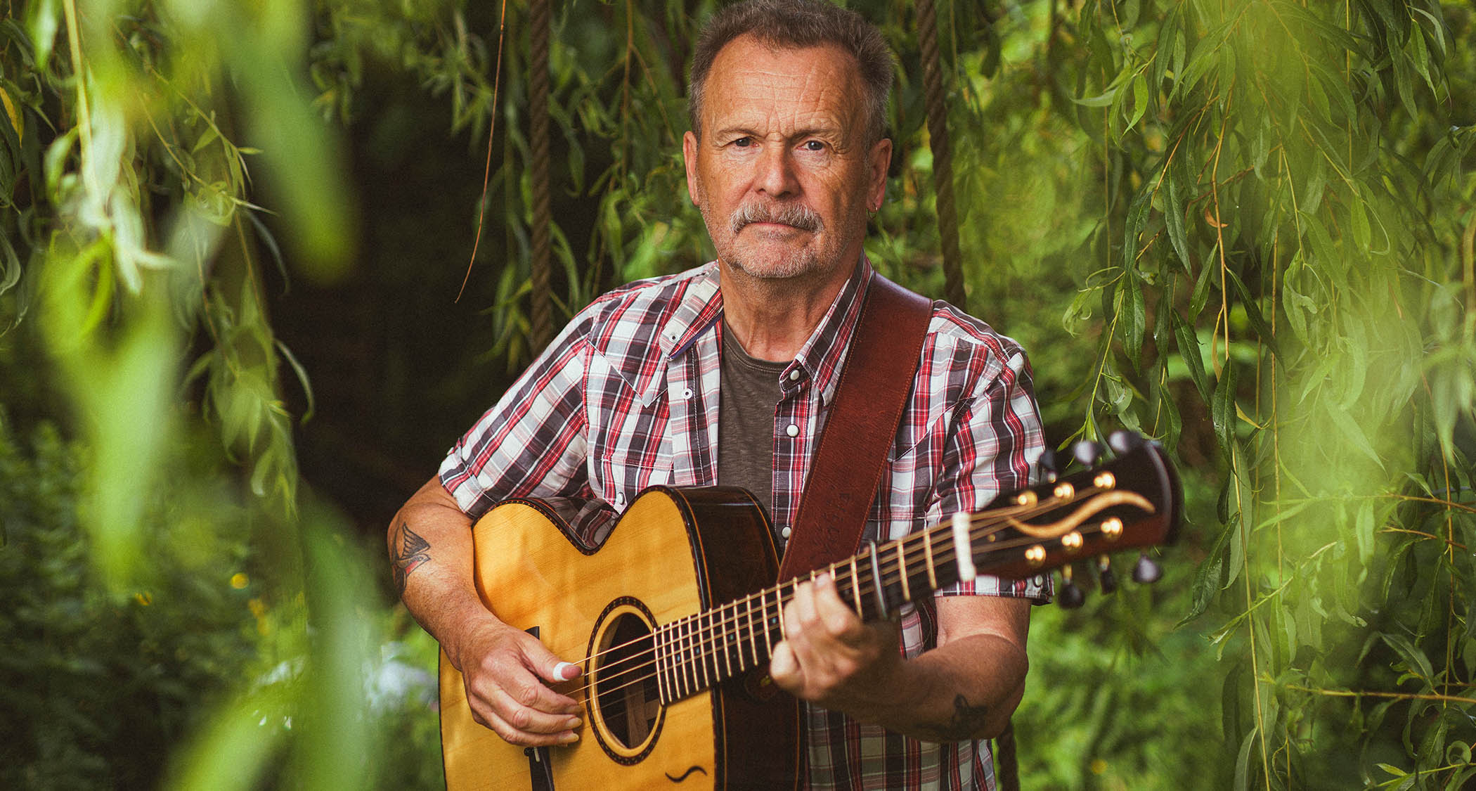 Martin Simpson at home with his acoustic guitar