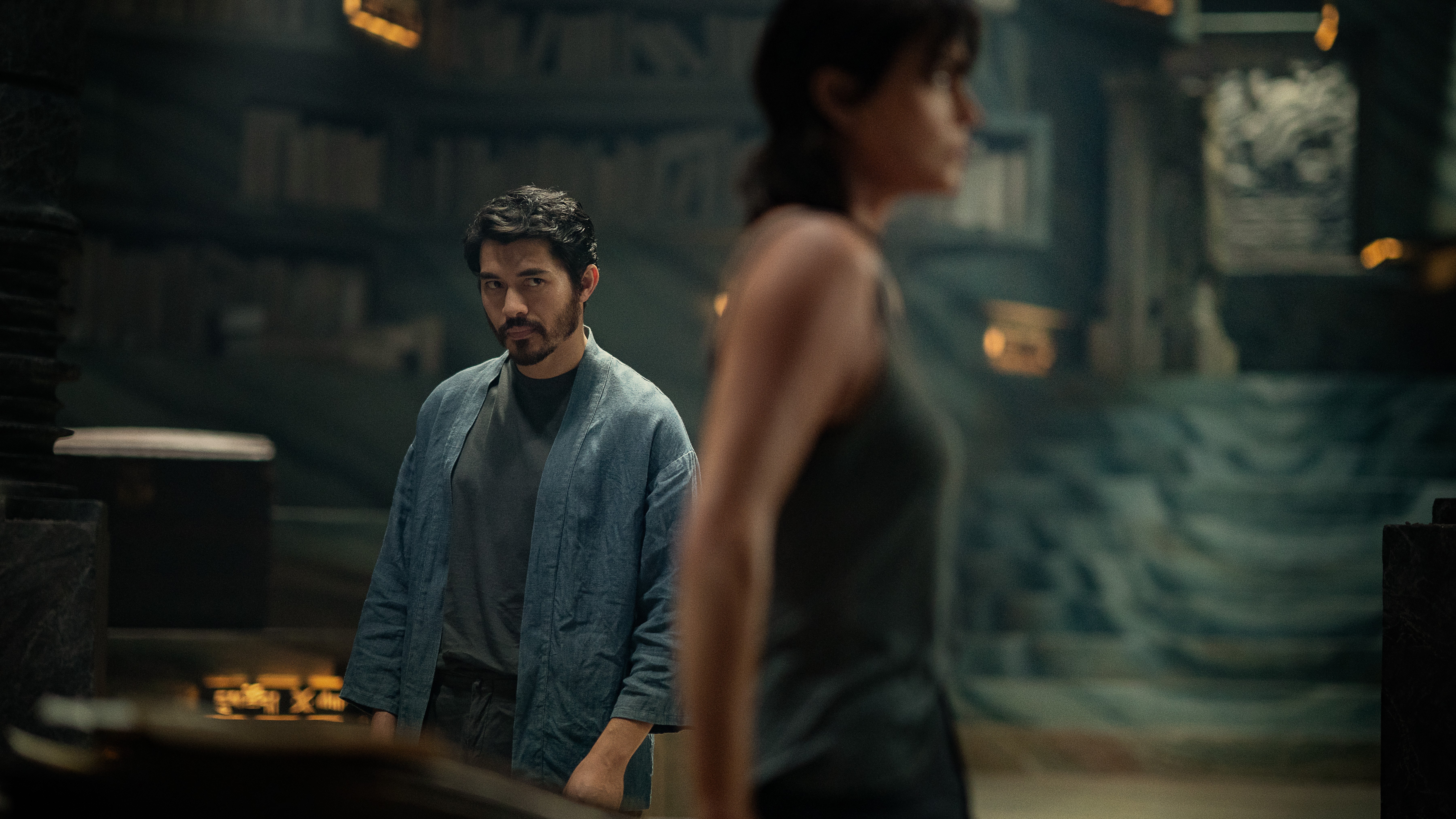 L-R: Tuah (Henry Golding) and Andy (Charlize Theron) in a scene from Netflix's "The Old Guard 2"