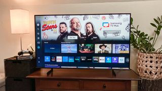 Samsung Q60D QLED TV on console in living room