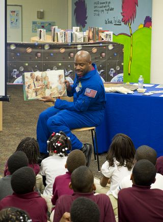 Former NASA astronaut Leland Melvin reads to first and third grade students from the book “The Moon Over Star” at Ferebee-Hope Elementary School in Washington, D.C. while serving as NASA's associate administrator for education in 2011. Melvin retired from NASA in 2014.