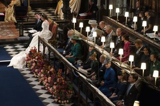 Jack Brooksbank and Princess Eugenie of York sit near the royal family including Queen Elizabeth II and Prince Philip, Duke of Edinburgh at their wedding