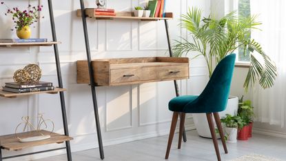 a neat wood and steel ladder desk design with velvet green chair in a living room by Wayfair