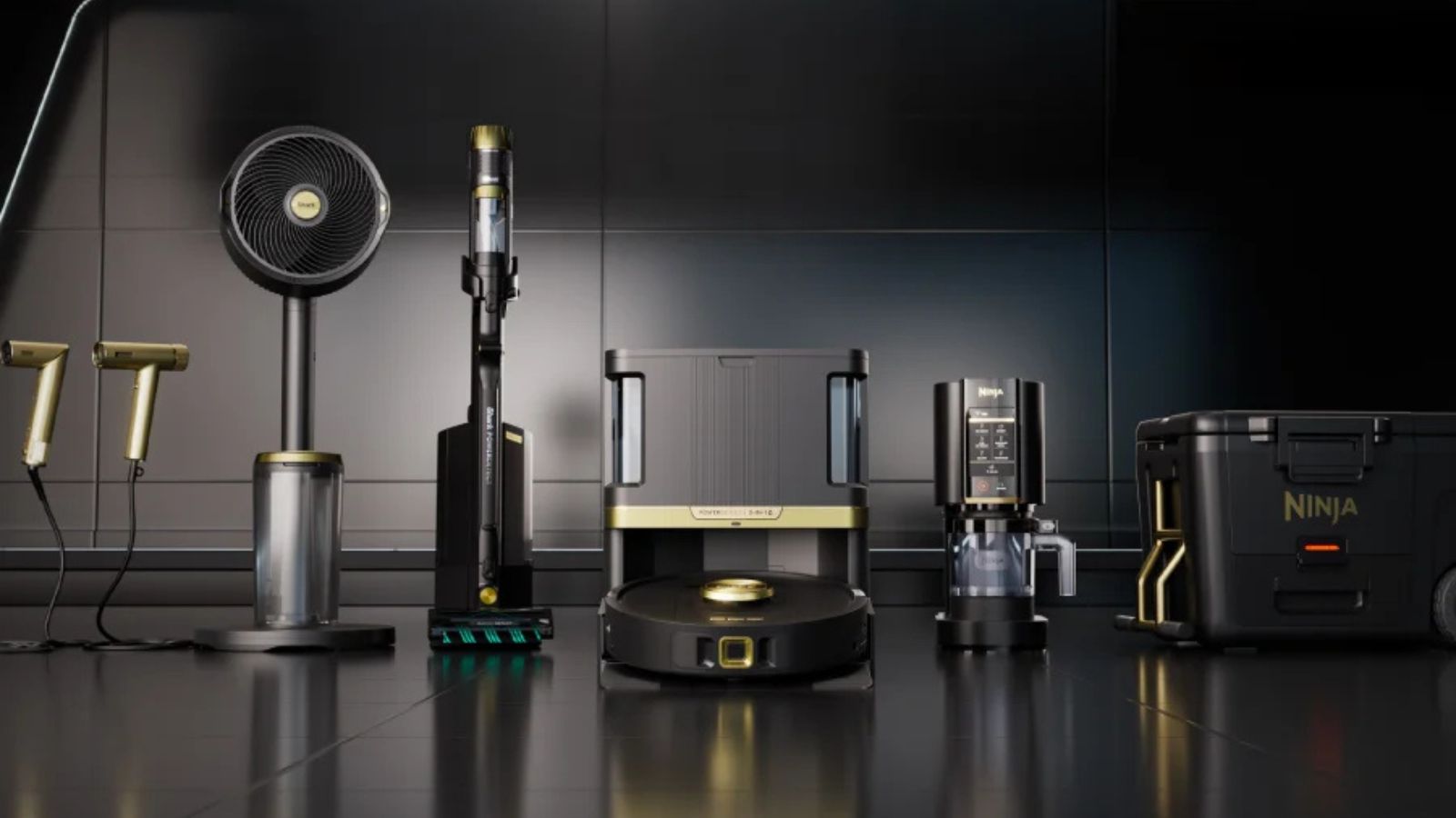 Lineup of Shark hair dryers, fan, cordless vacuum, robot vacuum, Ninja coffee maker and Ninja cool box in dark, metallic room.