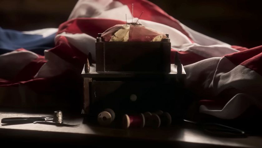 A screenshot from The American Revolution of a flag being sewn