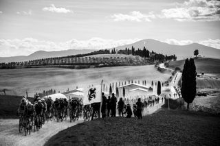 The pack rides through a gravel road during the oneday classic cycling race Strade Bianche White Roads on March 9 2019 around Siena Tuscany Photo by MARCO BERTORELLO AFP Photo credit should read MARCO BERTORELLOAFP via Getty Images
