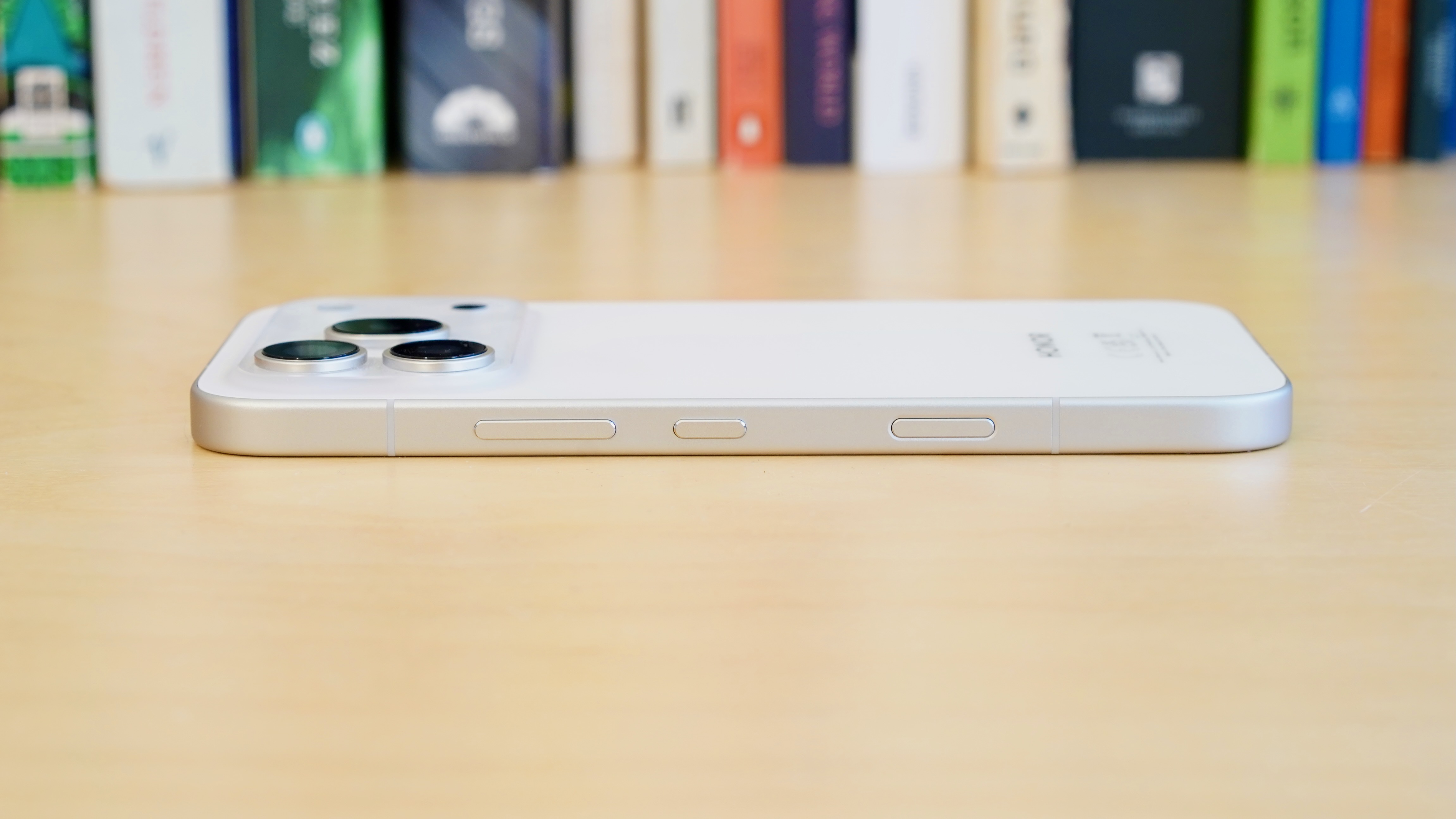 A white Honor 600 Pro resting on a wooden table
