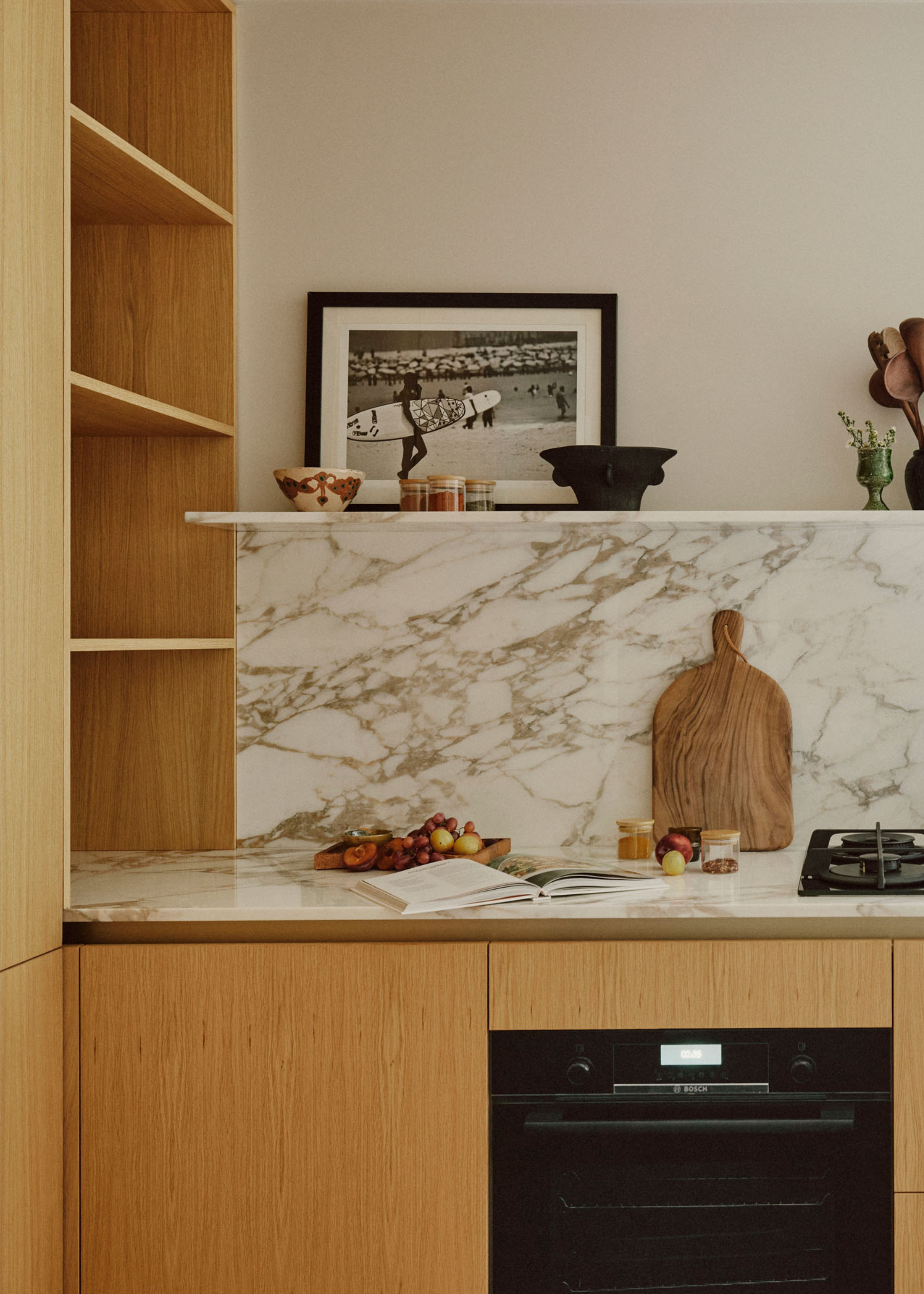 A small kitchen with open wooden shelving