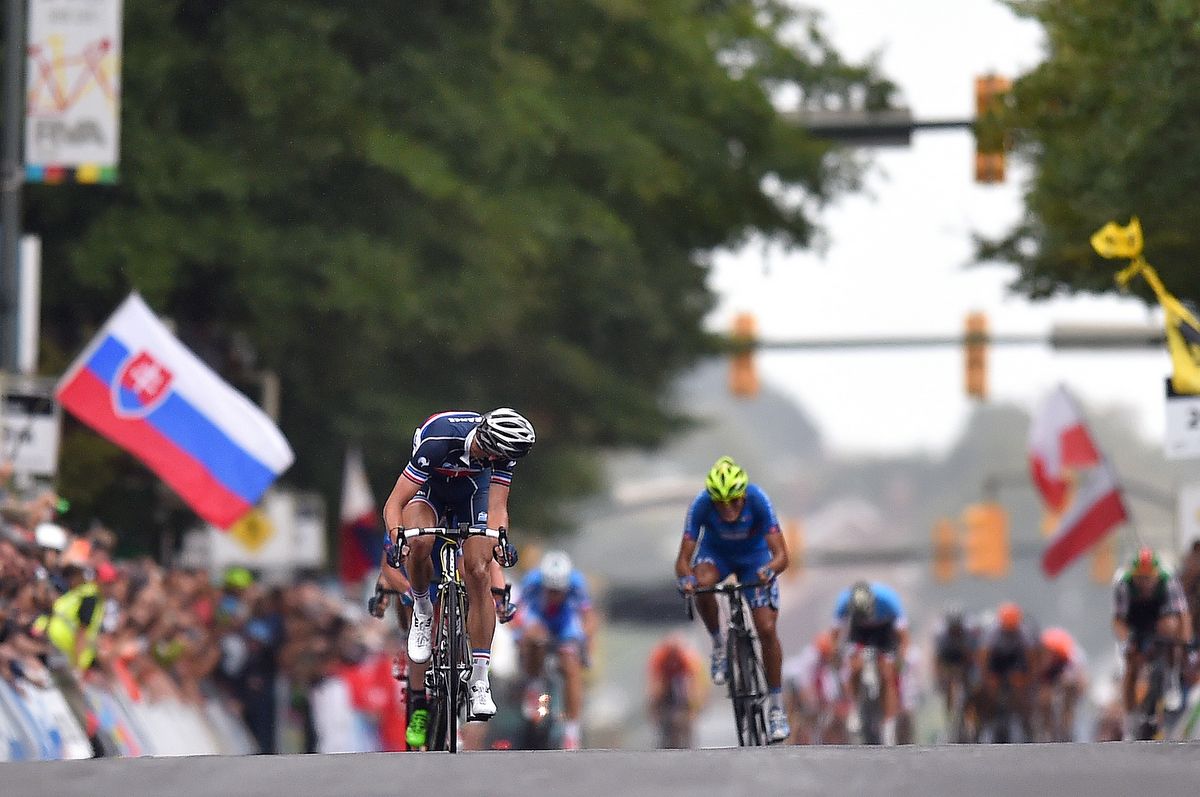 Kevin Ledanois (France) looks back to see the fast finishing peloton closing in