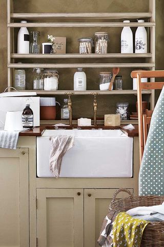 green laundry room with jars of laundry products