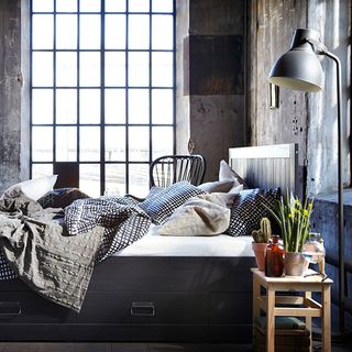 bed with wooden table and plant