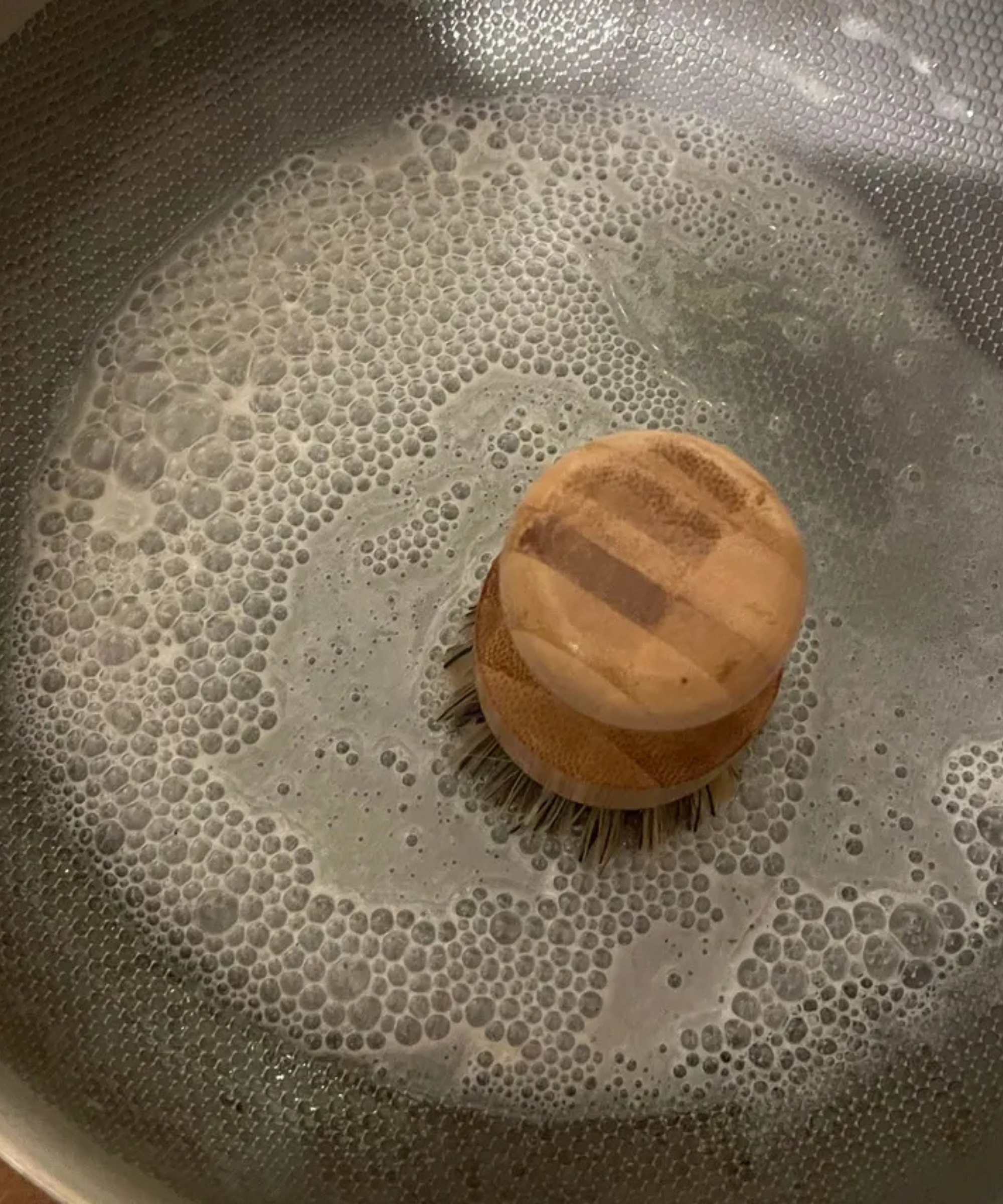 Cleaning the Our Place Titanium Always Pan Pro with the included brush