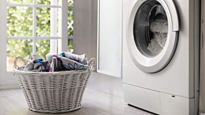 Laundry room with washing machine and laundry basket