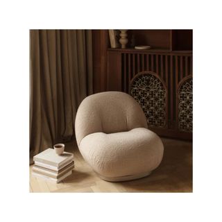 white boucle lounge chair on wooden floor