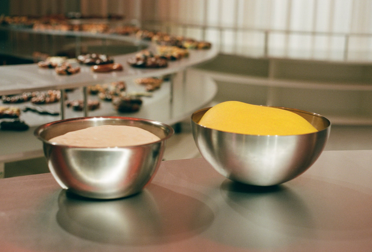 Dough balls in metal bowls.