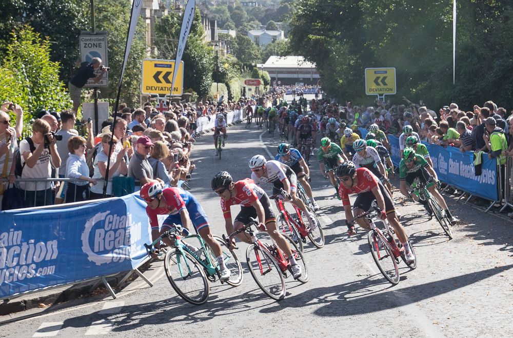 The peloton rounds the final corner at the Tour of Britain