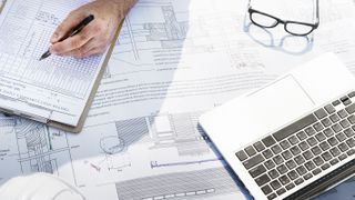 architectural plans with laptop