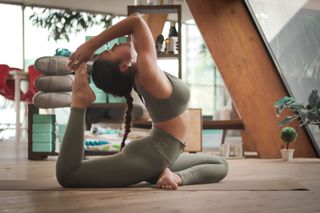 woman posing on yoga mat in loft