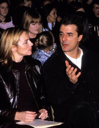 Kim Cattrall and Chris Noth chatting during a fashion show.