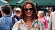 Pippa Middleton smiles, wearing sunglasses and a jumpsuit, as she arrives on day twelve of the 2024 Wimbledon Championships