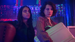 Geraldine Viswanathan and Margaret Qualley with suitcase in Drive-Away Dolls