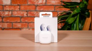 The Samsung Galaxy Live buds case in white on a wooden surface.