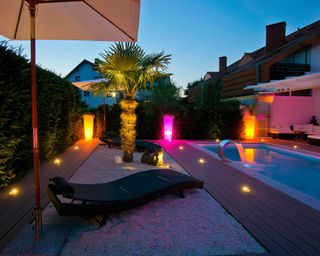 deck lighting around swimming pool in modern garden