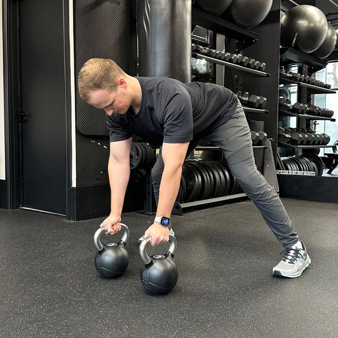 Personal trainer Ollie Thompson demonstrating a gorilla row