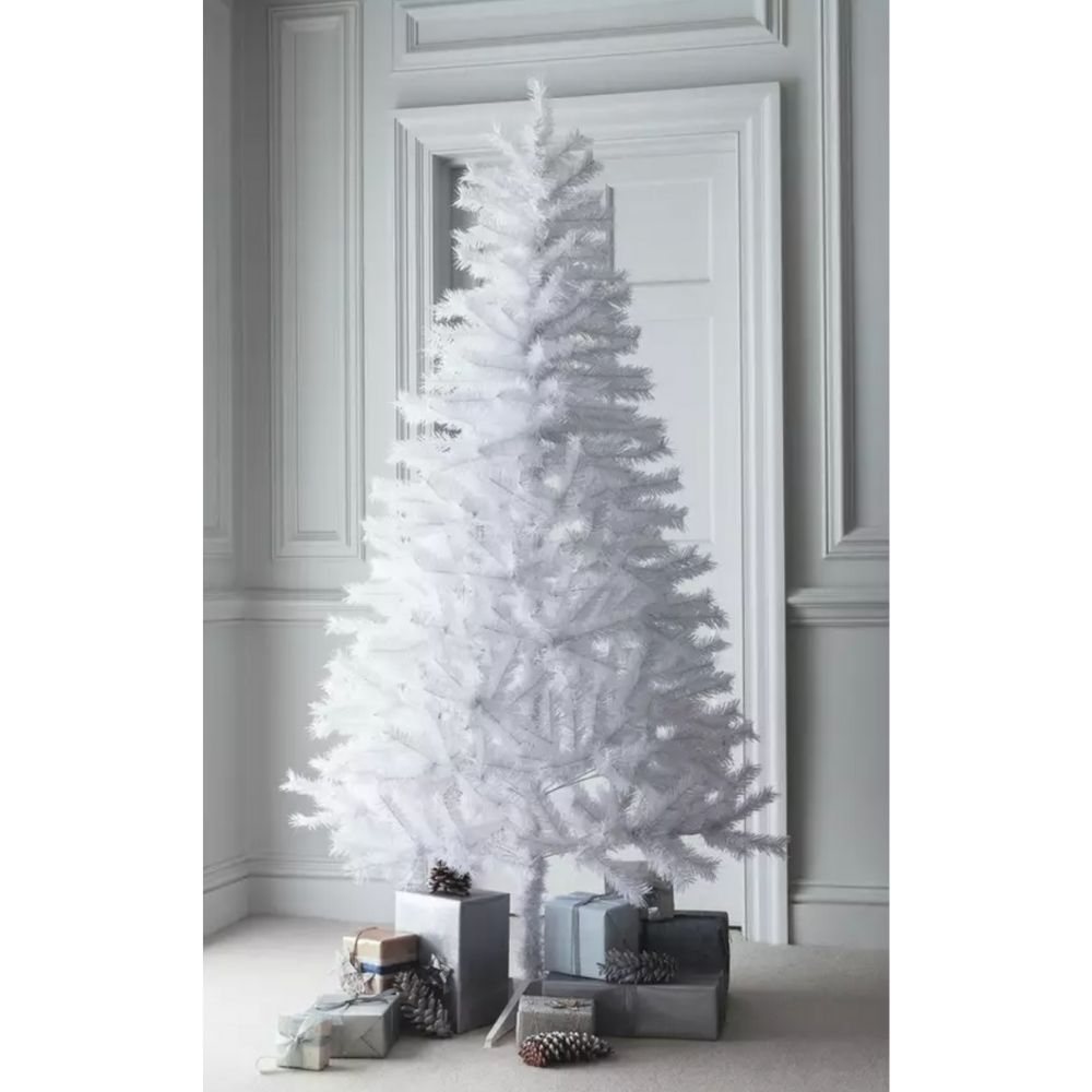 A pure white Christmas tree in a white room, surrounded by gifts.